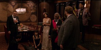 Movie still from “Murder Mystery” (2019), directed by Kyle Newacheck – A group of people standing in a room; Wide shot, Over the shoulder angle