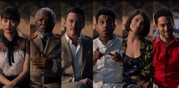 Movie still from “Murder Mystery” (2019), directed by Kyle Newacheck – A group of people that are posing for a picture; Medium shot, Overhead angle