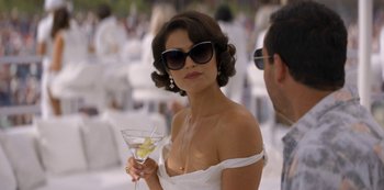 Movie still from “Murder Mystery” (2019), directed by Kyle Newacheck – A woman in a white dress holding a glass of wine; Close Up shot, Over the shoulder angle
