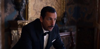 Movie still from “Murder Mystery” (2019), directed by Kyle Newacheck – A man wearing a suit and a bow tie; Close Up shot, Over the shoulder angle