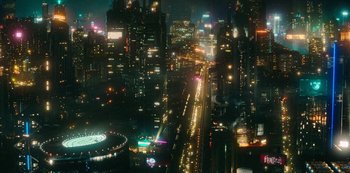 Movie still from “Mute” (2018), directed by Duncan Jones – An aerial view of a city lit up at night; Extreme Wide shot, High angle