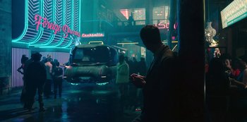 Movie still from “Mute” (2018), directed by Duncan Jones – A man standing in the middle of a street; Wide shot, Low angle