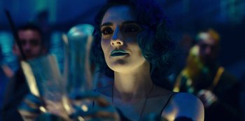 Movie still from “Mute” (2018), directed by Duncan Jones – A woman with blue hair looking into a mirror; Close Up shot, Low angle