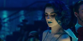 Movie still from “Mute” (2018), directed by Duncan Jones – A beautiful woman with blue hair and green lipstick; Close Up shot, Over the shoulder angle