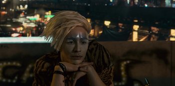 Movie still from “Mute” (2018), directed by Duncan Jones – A man with a silver face mask and blonde hair; Close Up shot, High angle
