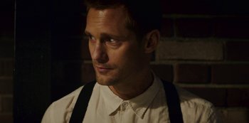 Movie still from “Mute” (2018), directed by Duncan Jones – A person wearing suspenders and a dress shirt; Close Up shot, Over the shoulder angle