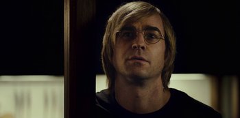 Movie still from “Mute” (2018), directed by Duncan Jones – A person wearing glasses; Close Up shot, Over the shoulder angle