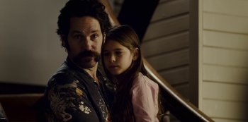 Movie still from “Mute” (2018), directed by Duncan Jones – A man and a little girl standing next to each other; Close Up shot, Over the shoulder angle