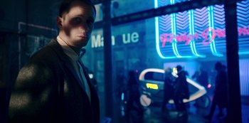 Movie still from “Mute” (2018), directed by Duncan Jones – A man standing in front of a neon sign at night; Medium shot, Over the shoulder angle