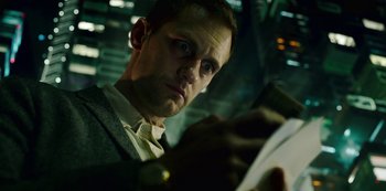 Movie still from “Mute” (2018), directed by Duncan Jones – A person looking at a book; Close Up shot, Low angle