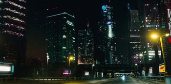 Movie still from “Mute” (2018), directed by Duncan Jones – A view of a city skyline at night time; Extreme Wide shot, Low angle