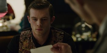Movie still from “Mute” (2018), directed by Duncan Jones – A young man is looking at a piece of paper; Close Up shot, Over the shoulder angle