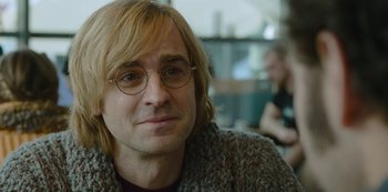 Movie still from “Mute” (2018), directed by Duncan Jones – A person wearing glasses; Close Up shot, Over the shoulder angle