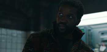 Movie still from “Mute” (2018), directed by Duncan Jones – A person wearing a jacket; Close Up shot, Over the shoulder angle