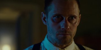 Movie still from “Mute” (2018), directed by Duncan Jones – A person wearing a white shirt; Close Up shot, Low angle