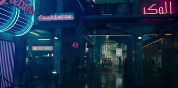 Movie still from “Mute” (2018), directed by Duncan Jones – A car parked in the middle of a street at night; Wide shot, High angle