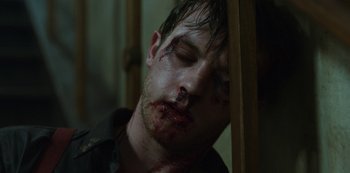 Movie still from “Mute” (2018), directed by Duncan Jones – A person with blood all over his face; Close Up shot, High angle