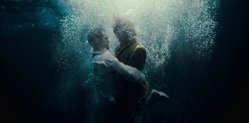 Movie still from “Mute” (2018), directed by Duncan Jones – Two men are hugging in the water together; Medium shot, Overhead angle