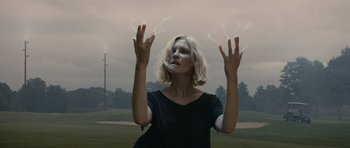 A woman with her hands in the air with smoke coming out of her hands