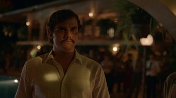 Movie still from “Narcos” (2015), created by Chris Brancato – A man in a white shirt with a mustache; Close Up shot, Low angle