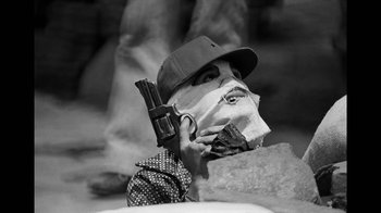 Movie still from “Narcos” (2015), created by Chris Brancato – A man with a gun and a mask on his face; Close Up shot, Low angle