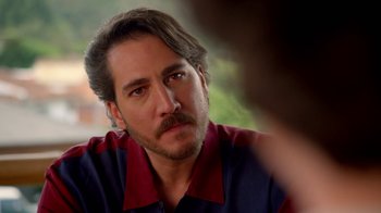 Movie still from “Narcos” (2015), created by Chris Brancato – A person with a beard; Close Up shot, Over the shoulder angle