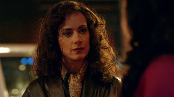 Movie still from “Narcos” (2015), created by Chris Brancato – A person with curly hair; Close Up shot, Over the shoulder angle