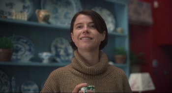 Movie still from “Men” (2022), directed by Alex Garland – A woman in a sweater holding a cup in her hand; Close Up shot, Low angle