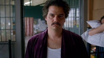 Movie still from “Narcos” (2015), created by Chris Brancato – A person with a mustache; Close Up shot, Low angle