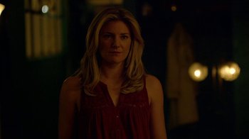 Movie still from “Narcos” (2015), created by Chris Brancato – A beautiful blonde woman in a red dress; Close Up shot, Over the shoulder angle