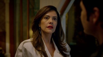 Movie still from “Narcos” (2015), created by Chris Brancato – A person with long hair; Close Up shot, Over the shoulder angle