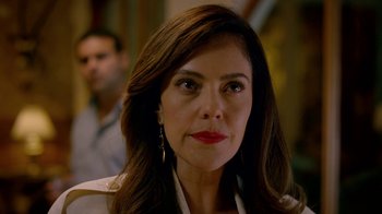 Movie still from “Narcos” (2015), created by Chris Brancato – A person with long brown hair; Close Up shot, Over the shoulder angle