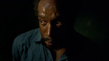 Movie still from “Narcos” (2015), created by Chris Brancato – A person wearing a blue shirt; Close Up shot, Low angle