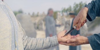 Movie still from “Midsommar” (2019), directed by Ari Aster – Two people are holding a pair of scissors in their hands; Extreme Close Up shot, Over the shoulder angle