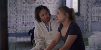 Movie still from “Midsommar” (2019), directed by Ari Aster – A man and a woman sitting next to each other; Medium shot, Over the shoulder angle