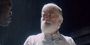 Movie still from “Midsommar” (2019), directed by Ari Aster – An old man with a white beard looking up; Close Up shot, Low angle