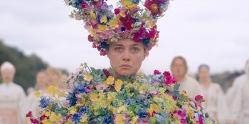 Movie still from “Midsommar” (2019), directed by Ari Aster – A woman in a floral dress and a flower crown; Medium shot, Low angle