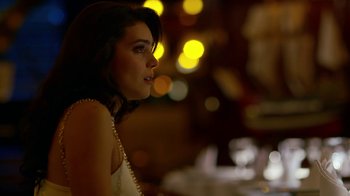 Movie still from “Narcos” (2015), created by Chris Brancato – A beautiful young lady wearing a white dress; Close Up shot, Over the shoulder angle