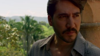Movie still from “Narcos” (2015), created by Chris Brancato – A person wearing a shirt; Close Up shot, Over the shoulder angle