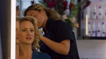 Movie still from “Narcos” (2015), created by Chris Brancato – A woman getting her hair done by a stylist; Close Up shot, Over the shoulder angle