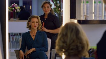 Movie still from “Narcos” (2015), created by Chris Brancato – Two women sitting in front of each other in front of a mirror; Medium shot, Over the shoulder angle