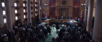 Movie still from “Miss Sloane” (2016), directed by John Madden – An audience is sitting in a court room; Extreme Wide shot, High angle