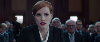 Movie still from “Miss Sloane” (2016), directed by John Madden – A person wearing a suit; Close Up shot, Over the shoulder angle