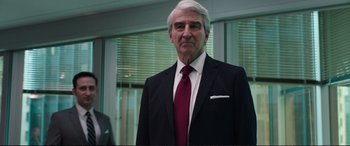 Movie still from “Miss Sloane” (2016), directed by John Madden – An older man wearing a suit and tie; Close Up shot, Over the shoulder angle