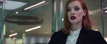 Movie still from “Miss Sloane” (2016), directed by John Madden – A woman with red hair wearing a black jacket; Close Up shot, Low angle