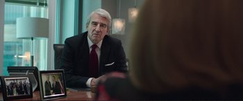 Movie still from “Miss Sloane” (2016), directed by John Madden – An older man sitting at a table in front of a woman; Close Up shot, Over the shoulder angle