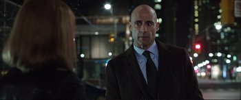 Movie still from “Miss Sloane” (2016), directed by John Madden – A man in a suit and tie standing next to a woman in a suit; Close Up shot, Over the shoulder angle