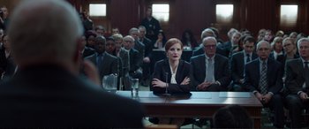 Movie still from “Miss Sloane” (2016), directed by John Madden – A group of people sitting at a table in a room; Medium shot, Over the shoulder angle