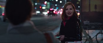 Movie still from “Miss Sloane” (2016), directed by John Madden – A woman standing next to a man on a street; Medium shot, Over the shoulder angle