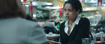 Movie still from “Miss Sloane” (2016), directed by John Madden – A woman sitting at a table in a restaurant; Close Up shot, Over the shoulder angle